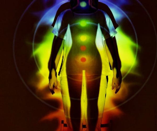 Silhouette of a person stretching against a sunrise, symbolizing energy.